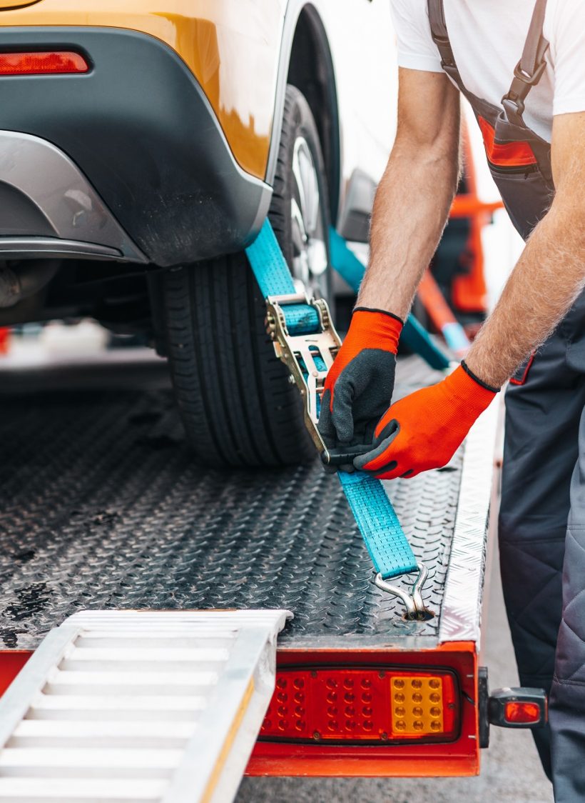 Handsome senior man working in towing service on the road. Roads Handsome senior man working in towing service on the road. Roadside assistance concept.